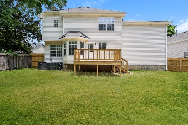 a view of a house with a yard and sitting area
