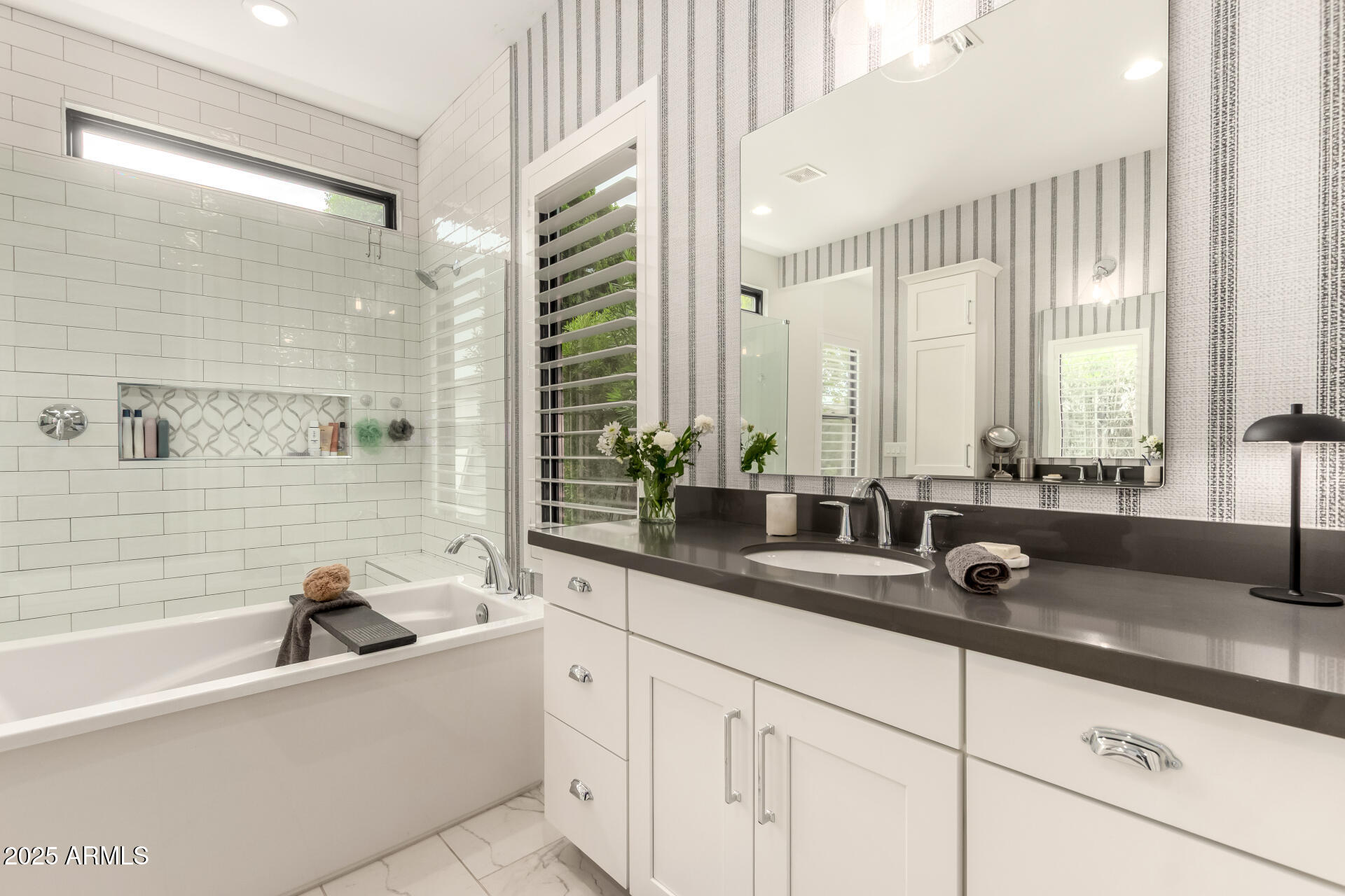 8723 North 9th Avenue Phoenix, AZ 85021 - Photo 20 of 34 a bathroom with double vanity sinks a large mirror and a bathtub