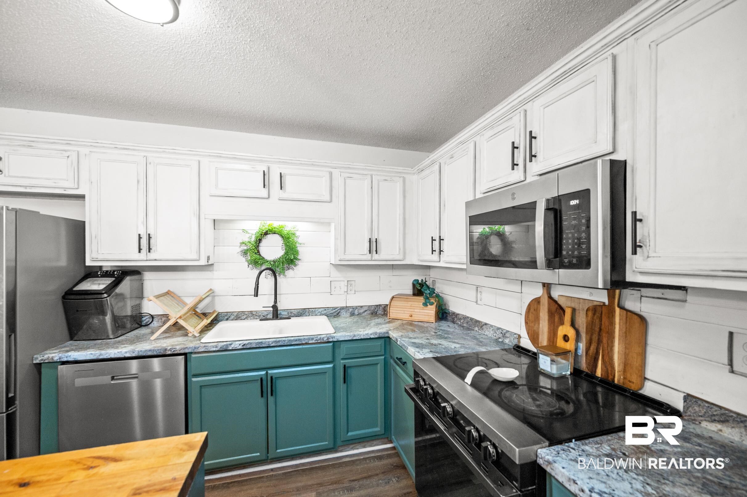 1603 Abbey Loop Foley, AL 36535 - Photo 12 of 35 Kitchen with stainless steel appliances, white cabinets, and sink