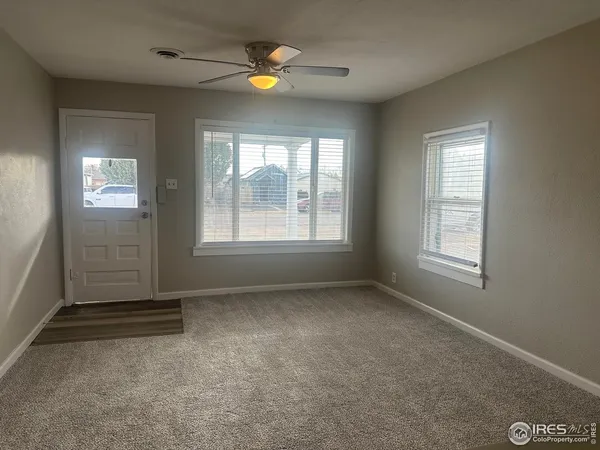 an empty room with windows and closet