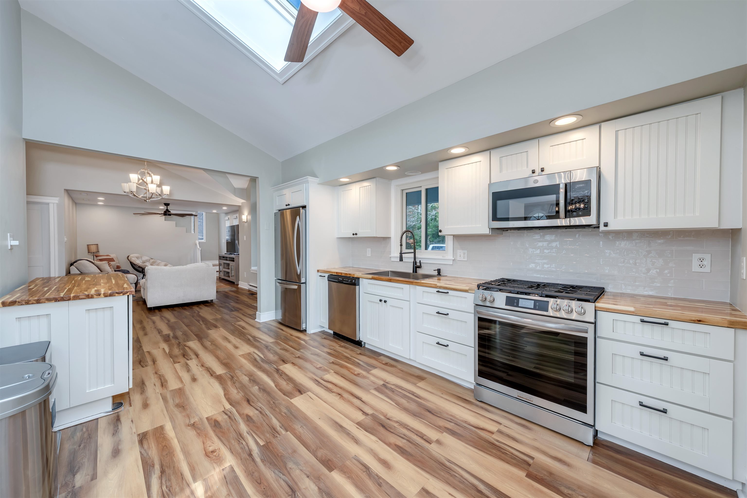 667 Dias Creek Road Cape May Court House, NJ 08210 - Photo 11 of 43 a kitchen with stainless steel appliances granite countertop a stove and white cabinets
