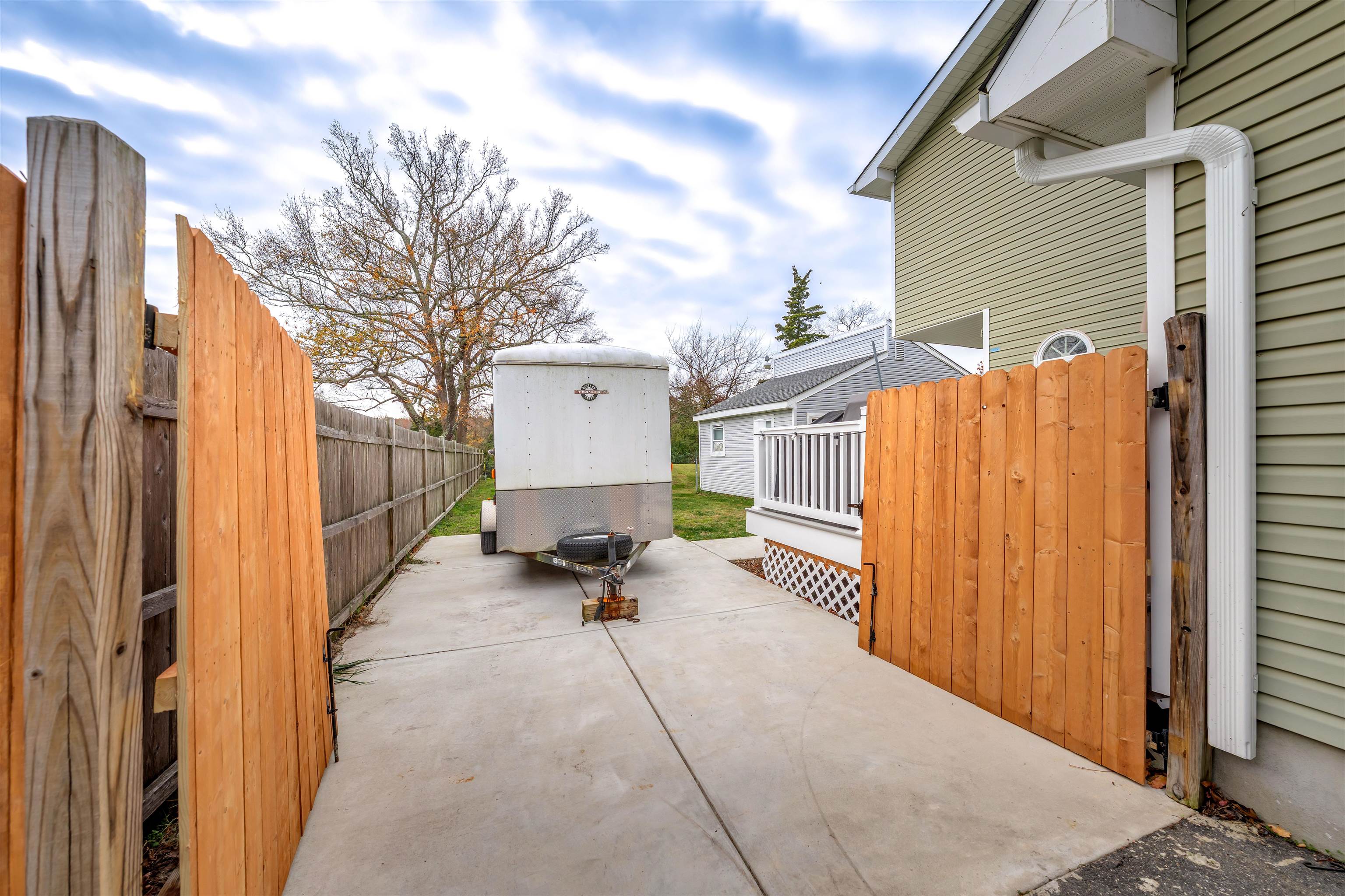 667 Dias Creek Road Cape May Court House, NJ 08210 - Photo 34 of 43 a view of a patio with a table and chairs and couches with wooden fence