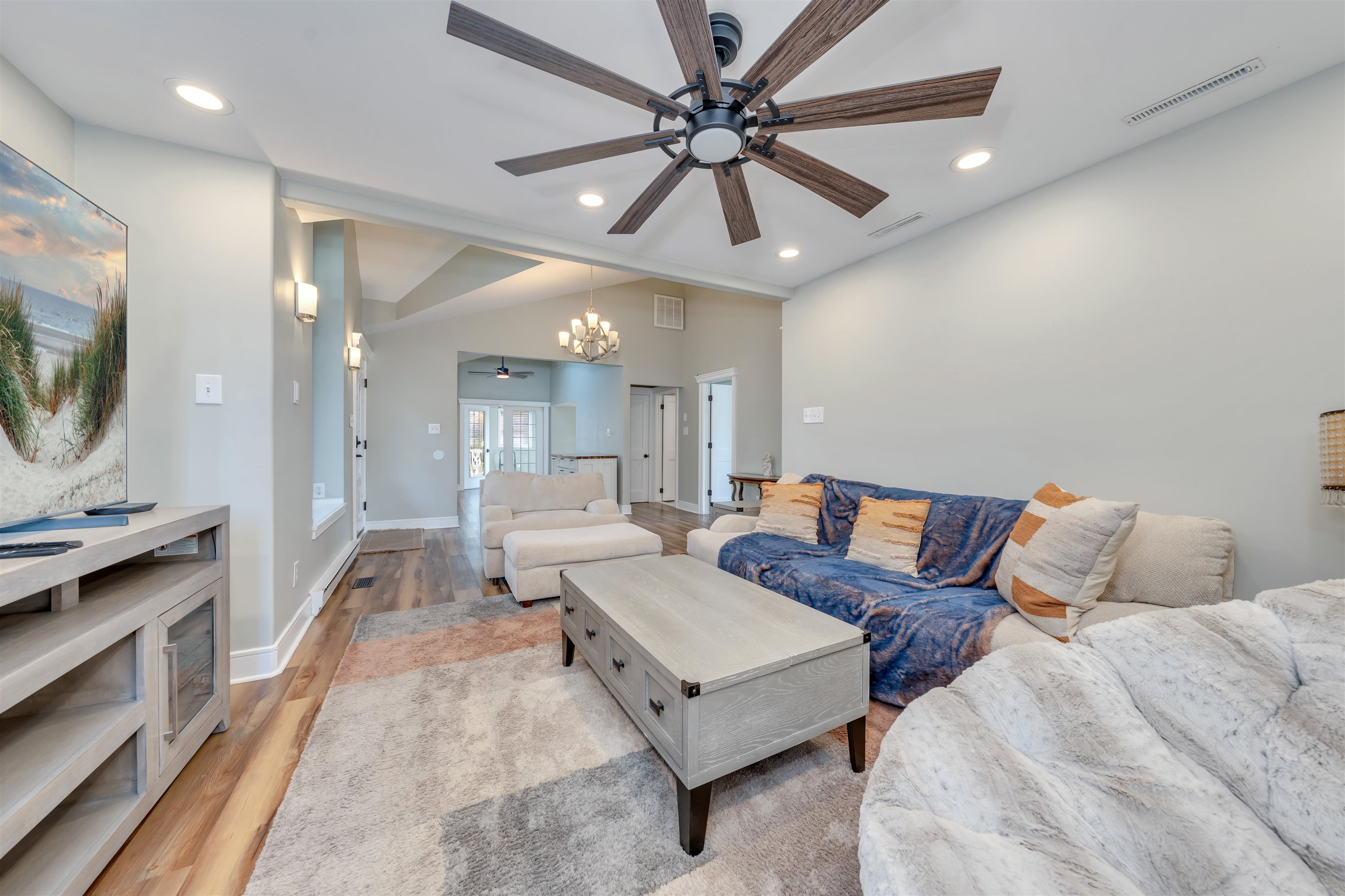 667 Dias Creek Road Cape May Court House, NJ 08210 - Photo 7 of 43 a living room with furniture a chandelier and a flat screen tv