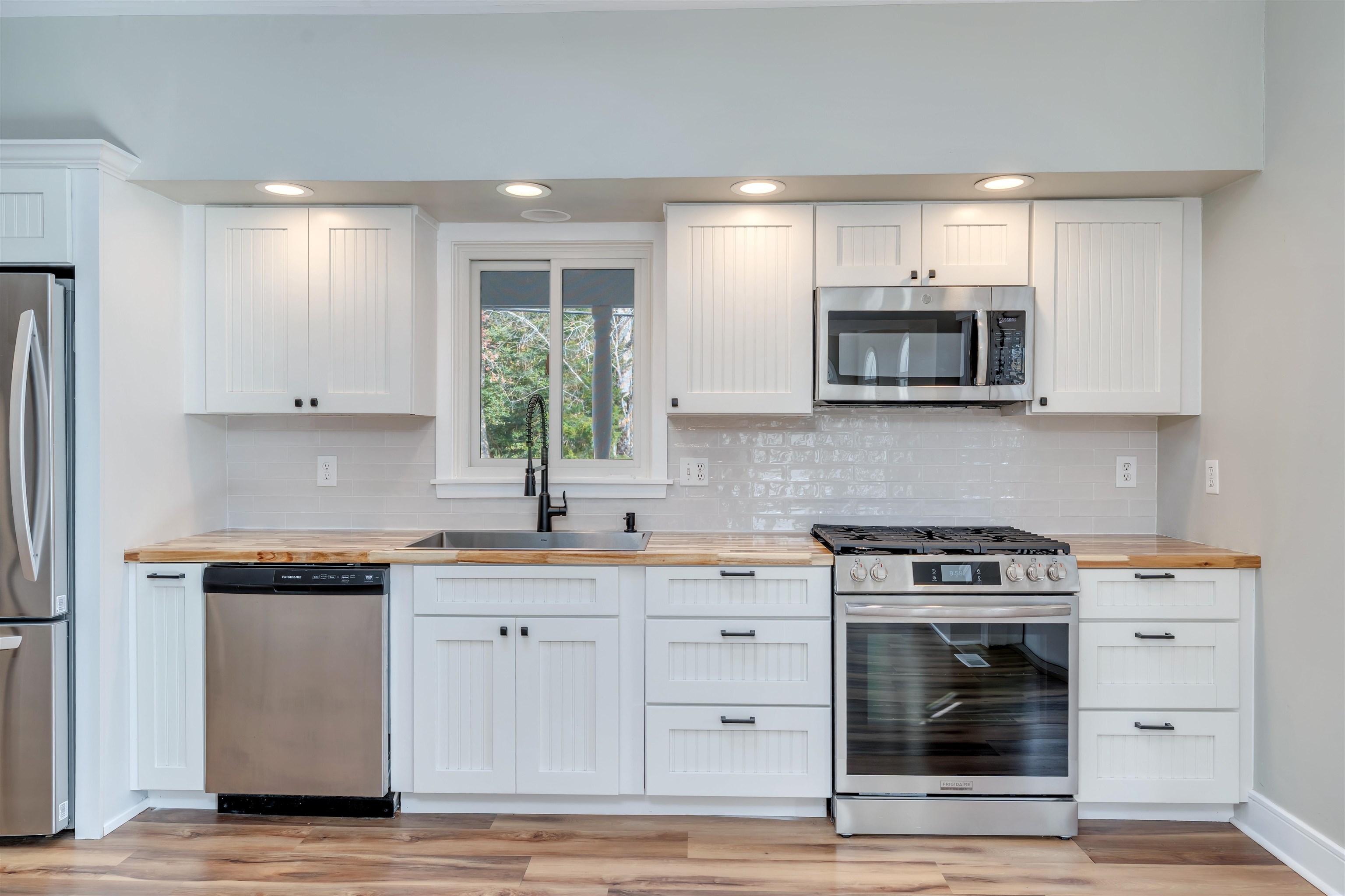 667 Dias Creek Road Cape May Court House, NJ 08210 - Photo 10 of 43 a kitchen with stainless steel appliances granite countertop a stove a sink and a microwave