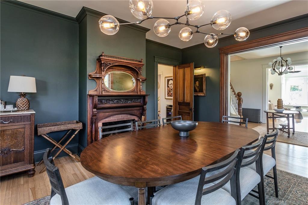 49 Christian Street Washington, CT 06777 - Photo 11 of 40 a dining room with wooden floor a chandelier a wooden table and chairs