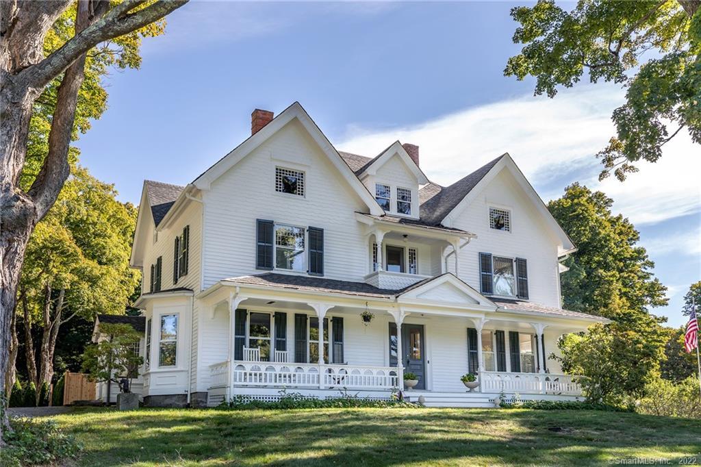 49 Christian Street Washington, CT 06777 - Photo 2 of 40 a front view of a house with a garden and swimming pool