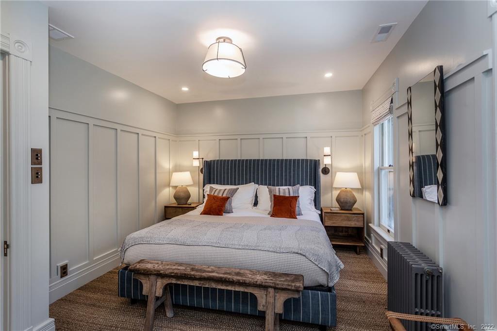 49 Christian Street Washington, CT 06777 - Photo 27 of 40 a bedroom with a bed and a chandelier