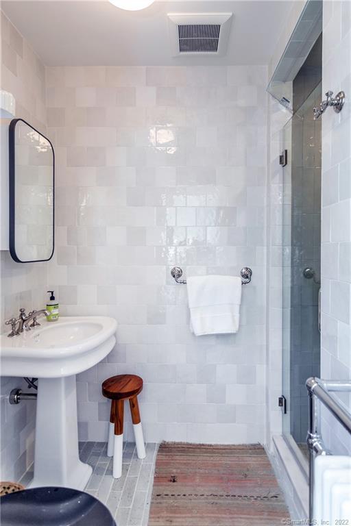49 Christian Street Washington, CT 06777 - Photo 28 of 40 a bathroom with a sink and a mirror