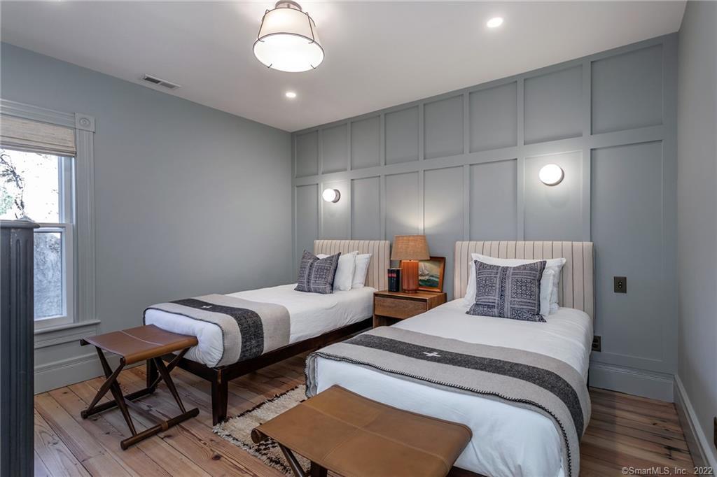 49 Christian Street Washington, CT 06777 - Photo 32 of 40 a bedroom with two beds and a chandelier