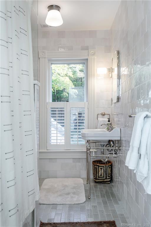 49 Christian Street Washington, CT 06777 - Photo 33 of 40 a spacious bathroom with a sink and a mirror
