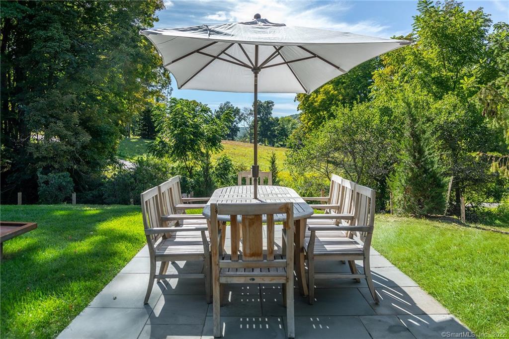49 Christian Street Washington, CT 06777 - Photo 5 of 40 a view of a table and chairs under an umbrella