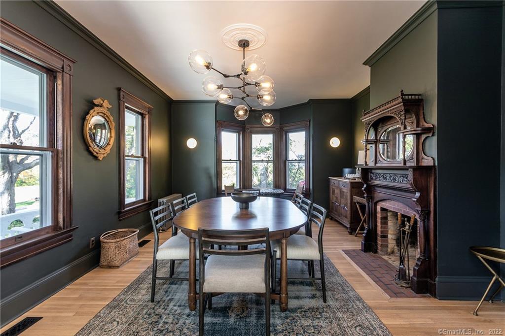 49 Christian Street Washington, CT 06777 - Photo 10 of 40 a dining room with wooden floor a chandelier a wooden table and chairs
