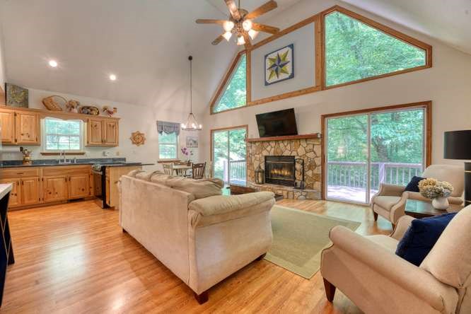 3333 Ellington Road Hayesville, NC 28904 - Photo 29 of 56 a living room with furniture a large window and a fireplace