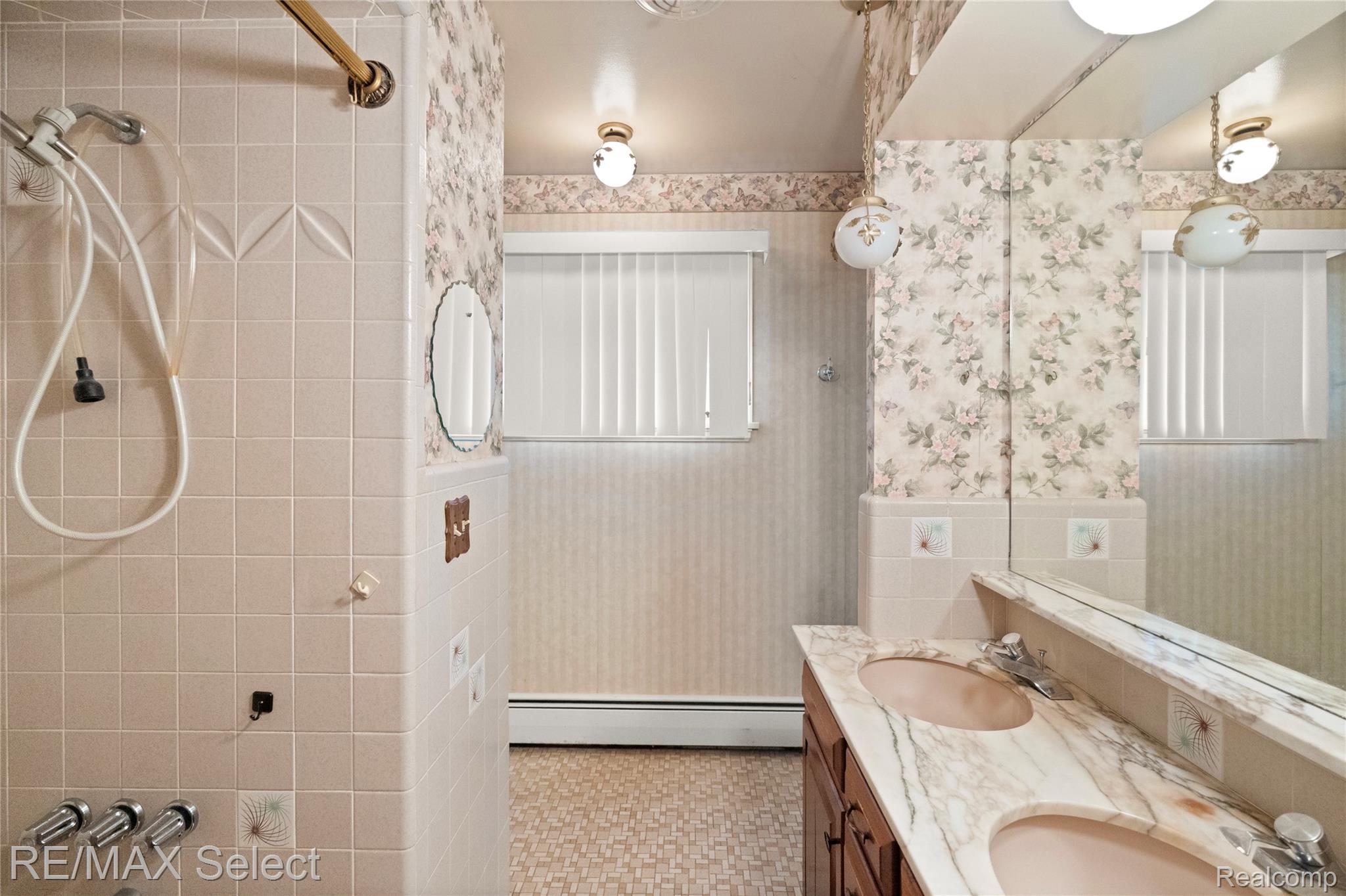 11080 Lapeer Road Davison, MI 48423 - Photo 49 of 64 Bathroom featuring a dual vanity with a patterned countertop, integrated sinks, and polished chrome fixtures