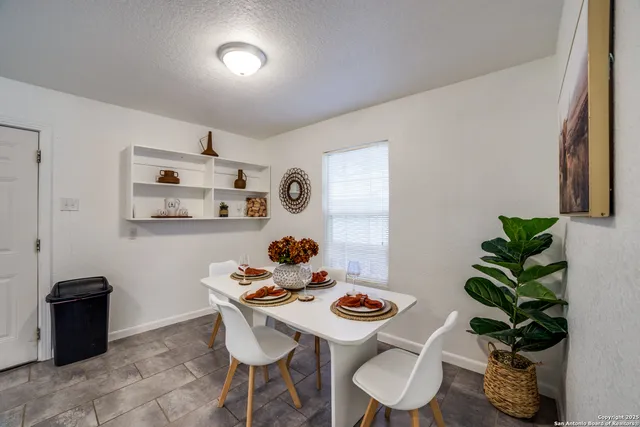 a view of a workspace with furniture and a potted plant