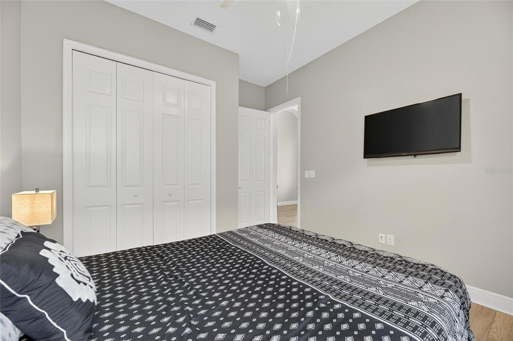 7223 Bowspirit Place Apollo Beach, FL 33572 - Photo 16 of 92 a bedroom with a bed and a flat screen tv