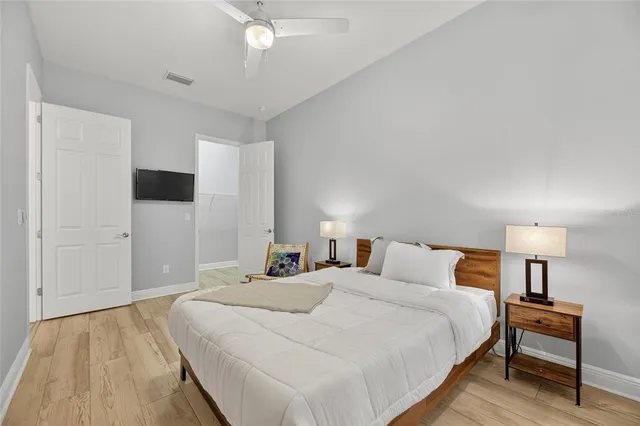 a bedroom with a large bed and a flat screen tv