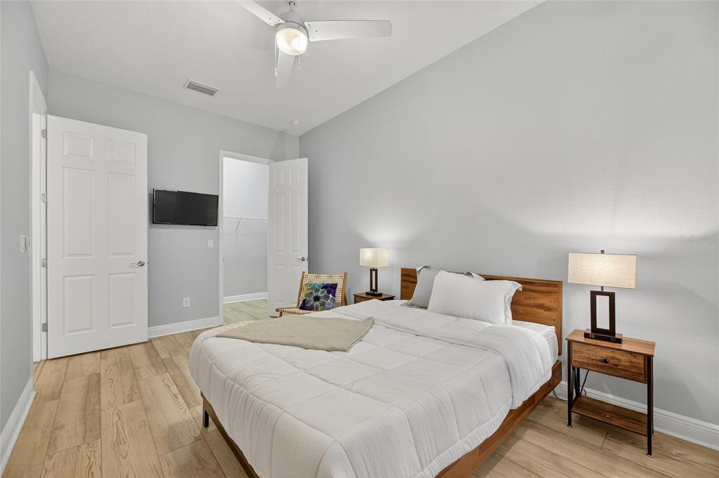 7223 Bowspirit Place Apollo Beach, FL 33572 - Photo 18 of 92 a bedroom with a bed and a lamp on table