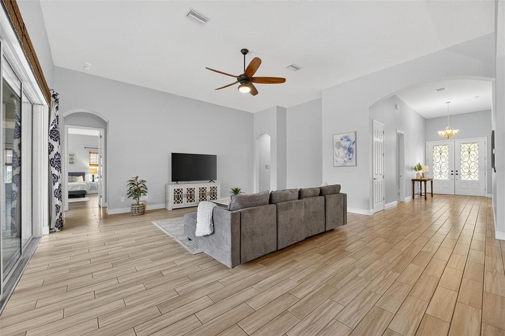 7223 Bowspirit Place Apollo Beach, FL 33572 - Photo 24 of 92 a living room with couches and a flat screen tv with kitchen view