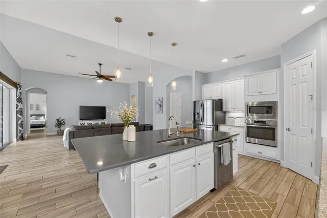 a view of a patio with a table chairs and a floor to ceiling window