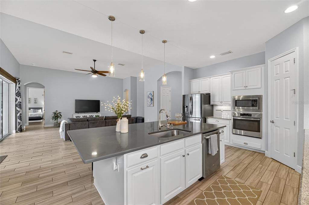 7223 Bowspirit Place Apollo Beach, FL 33572 - Photo 29 of 92 a large kitchen with kitchen island granite countertop a large counter top appliances and cabinets