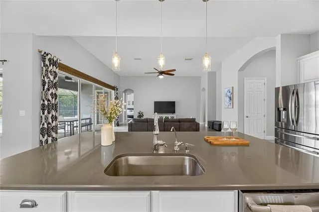 an aerial view of a house with a yard and a car park