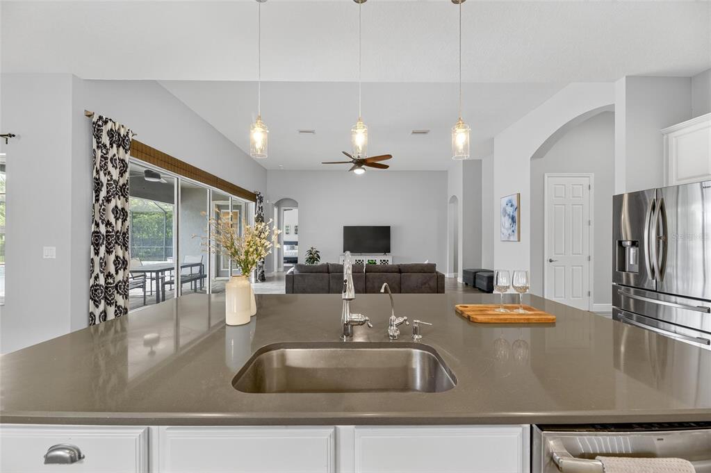 7223 Bowspirit Place Apollo Beach, FL 33572 - Photo 30 of 92 a kitchen with kitchen island a counter top space a sink and stainless steel appliances