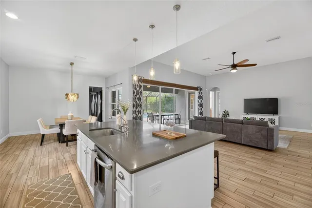 a living room with furniture a flat screen tv and large window