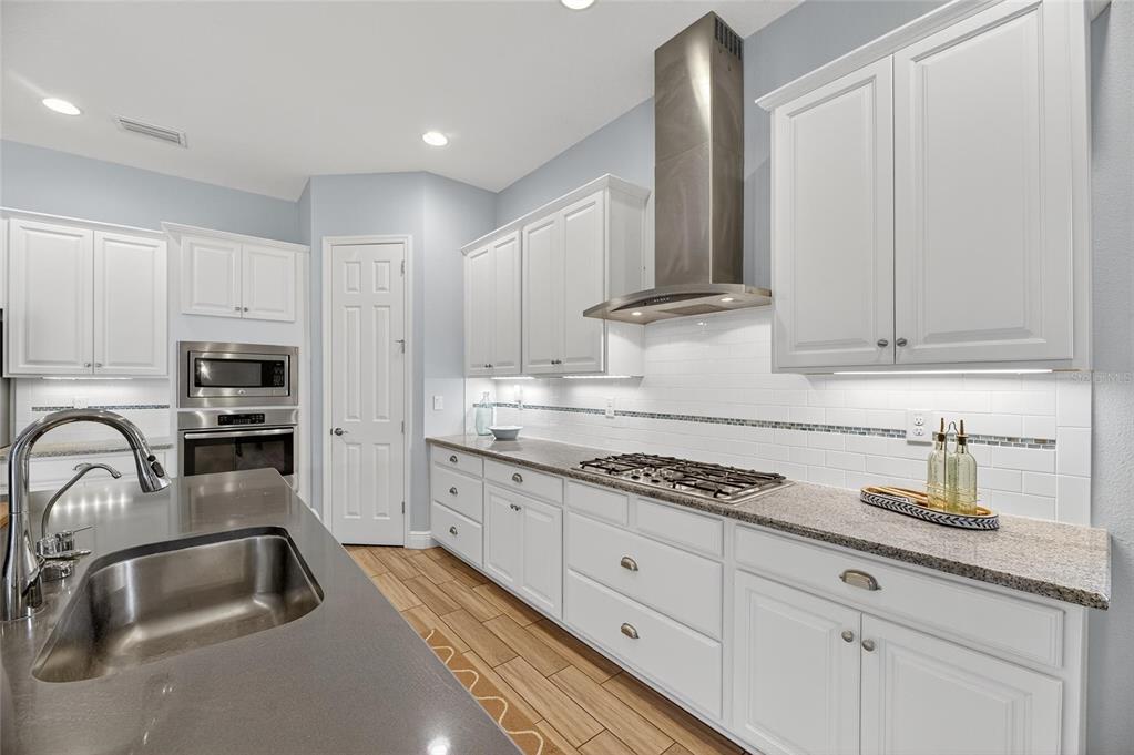 7223 Bowspirit Place Apollo Beach, FL 33572 - Photo 34 of 92 a kitchen with granite countertop a sink a stove and cabinets