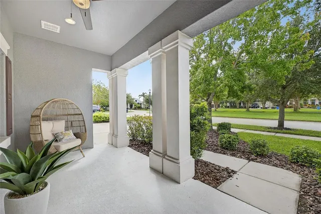 a living room with couches and a flat screen tv with kitchen view