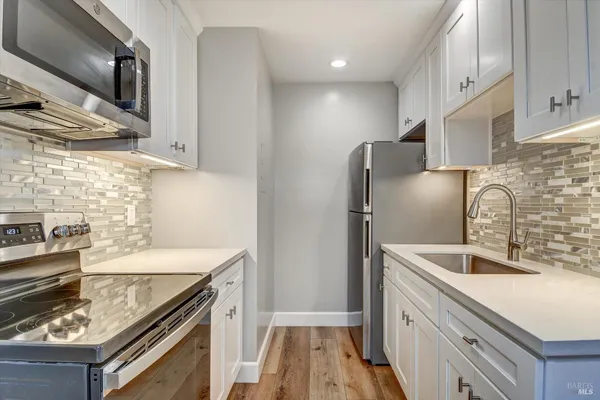 a kitchen with a stove microwave and sink