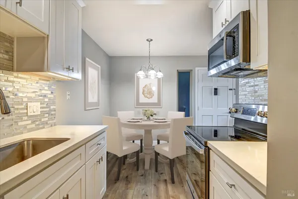 a kitchen with a sink stove and cabinets