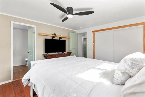 a bedroom with a bed and a flat screen tv