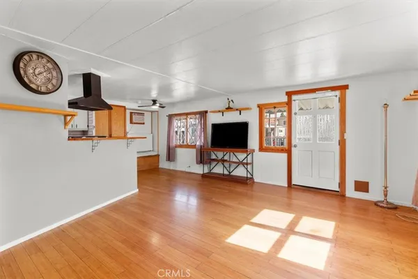 a view of a livingroom with furniture a flat screen tv