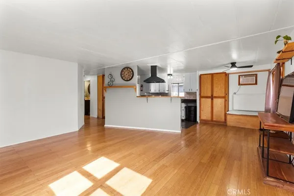 a view of a kitchen with a sink and a refrigerator