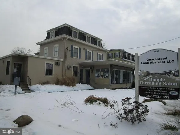 a view of a house with a snow in the background