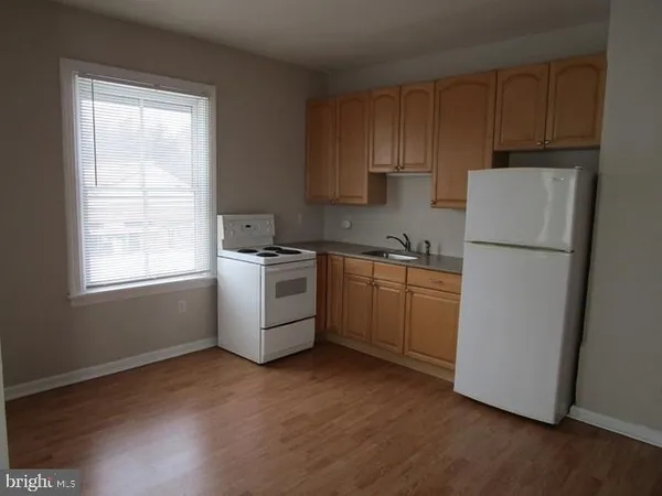 a kitchen with a white cabinets and white appliances