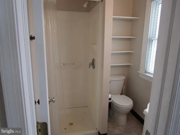 a white toilet sitting next to a bathroom sink