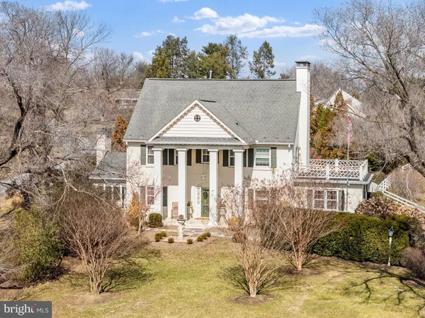 a view of a house with backyard porch and sitting area