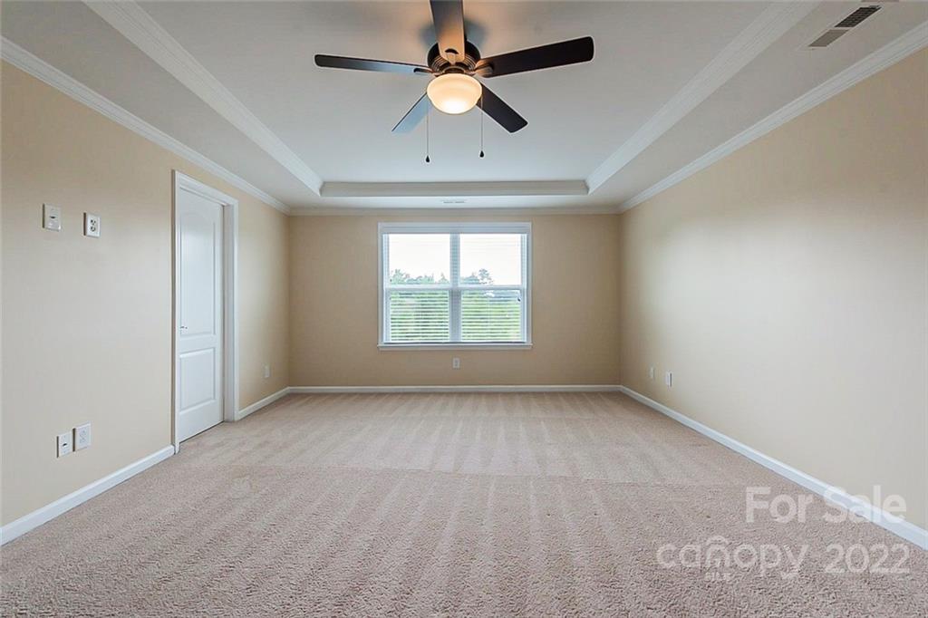 210 Keating Pl Drive Fort Mill, SC 29708 - Photo 9 of 20 an empty room with a window and a ceiling fan