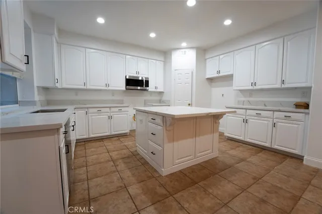 a kitchen with a stove sink and cabinets
