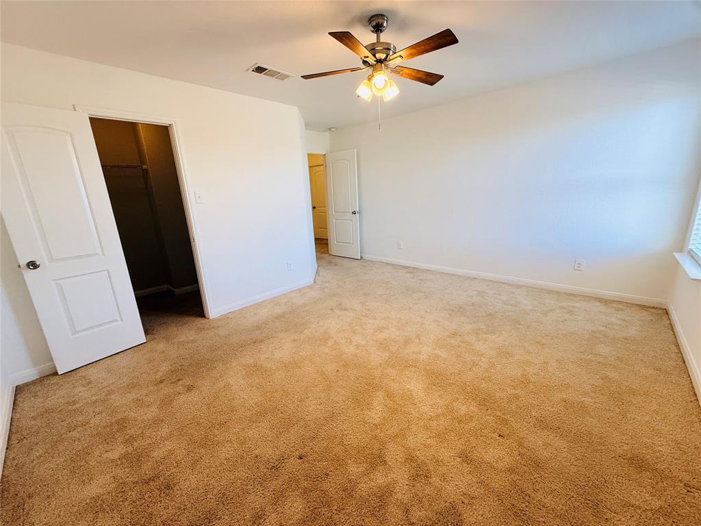 223 Magnolia Drive Princeton, TX 75407 - Photo 18 of 29 a view of a big room with closet and a ceiling fan