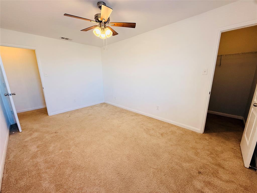 223 Magnolia Drive Princeton, TX 75407 - Photo 21 of 29 an empty room with a window and a ceiling fan