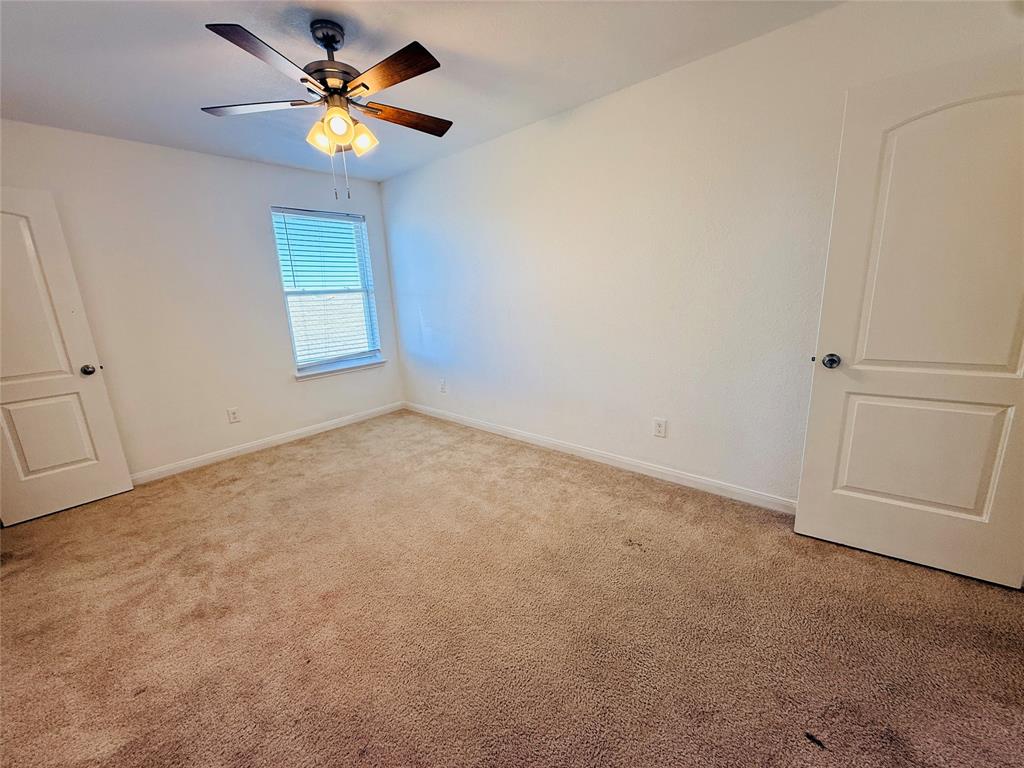 223 Magnolia Drive Princeton, TX 75407 - Photo 22 of 29 an empty room with a window and a fan
