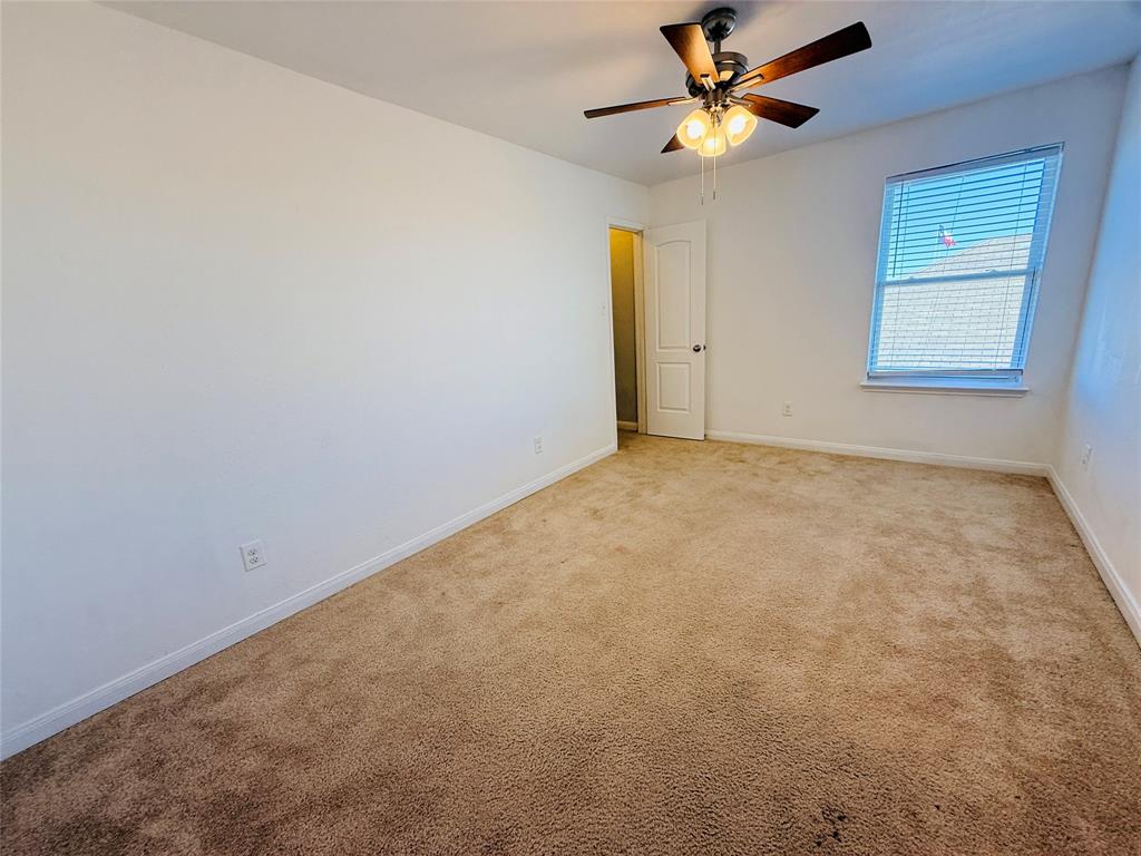 223 Magnolia Drive Princeton, TX 75407 - Photo 23 of 29 an empty room with windows and fan