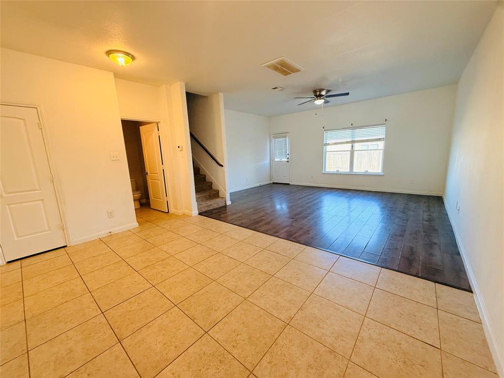 223 Magnolia Drive Princeton, TX 75407 - Photo 8 of 29 a view of empty room with wooden floor and fan