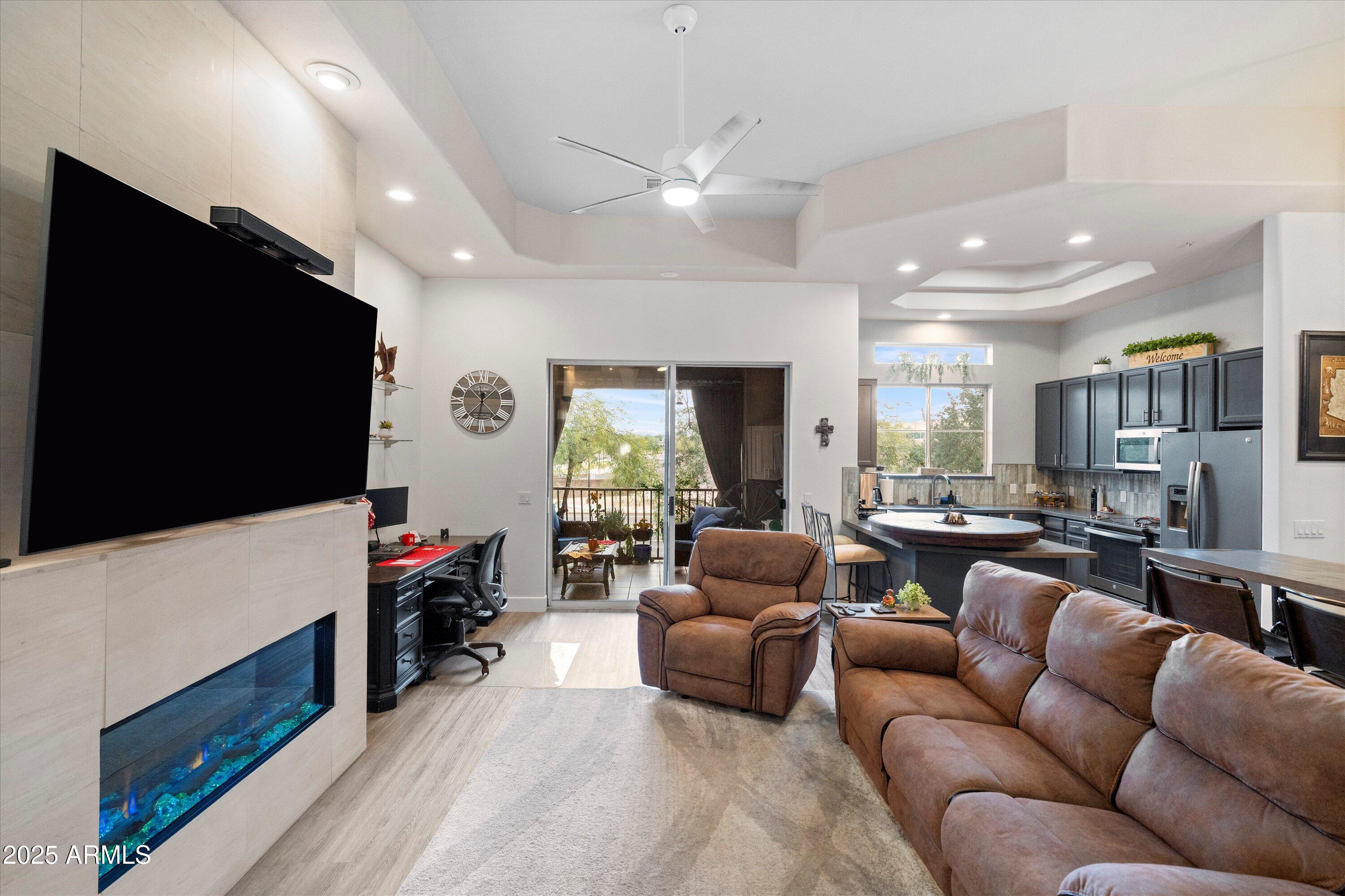 8245 East Bell Road, Unit 250 Scottsdale, AZ 85260 - Photo 8 of 48 a living room with furniture and a flat screen tv