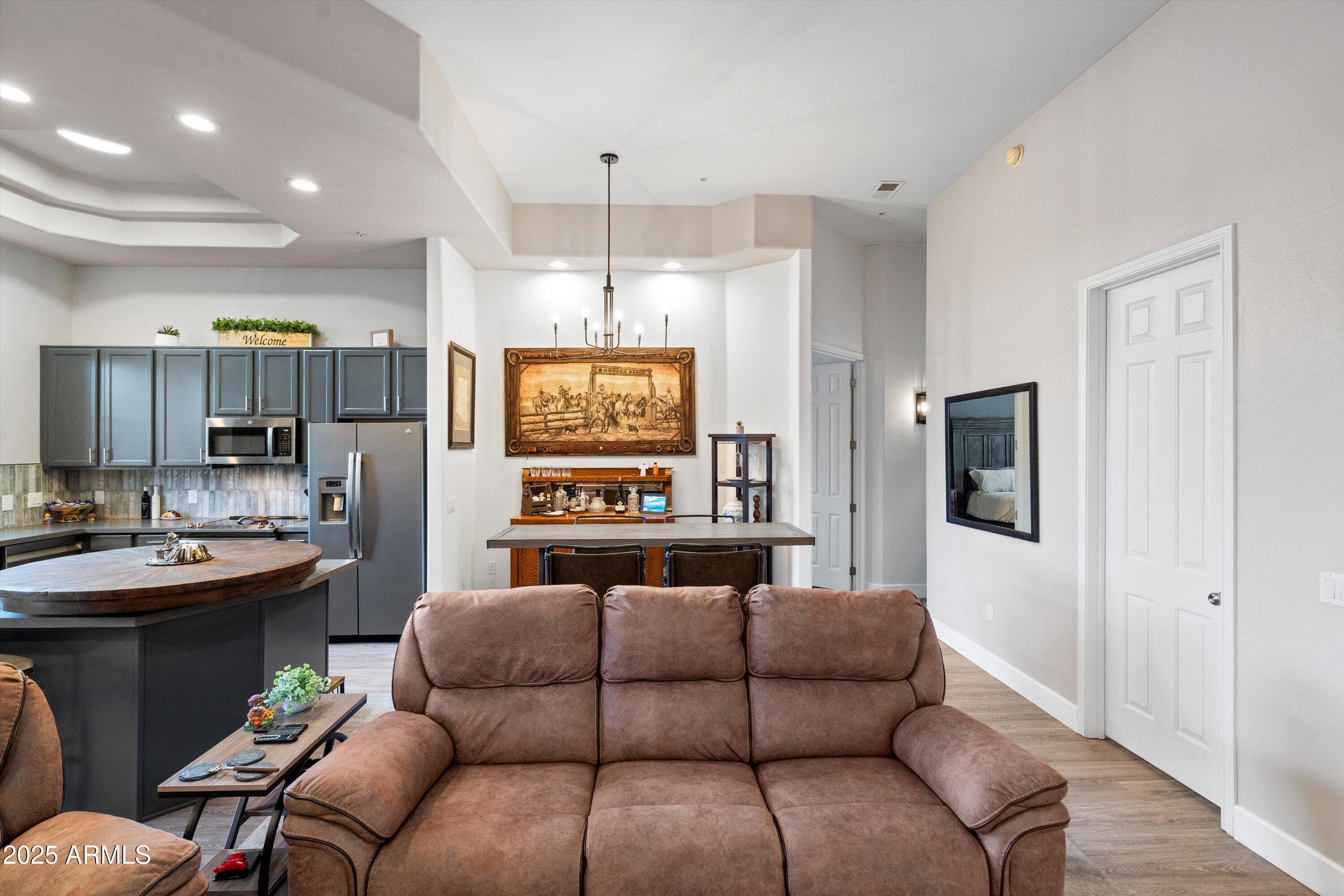 8245 East Bell Road, Unit 250 Scottsdale, AZ 85260 - Photo 13 of 48 a living room with furniture kitchen and a wooden floor