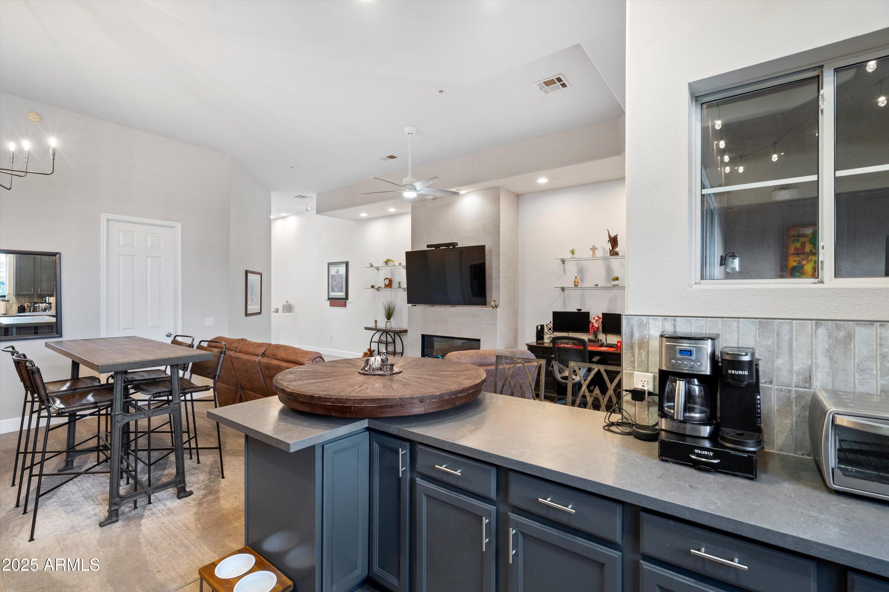 8245 East Bell Road, Unit 250 Scottsdale, AZ 85260 - Photo 18 of 48 a kitchen with lots of counter top space and dining table