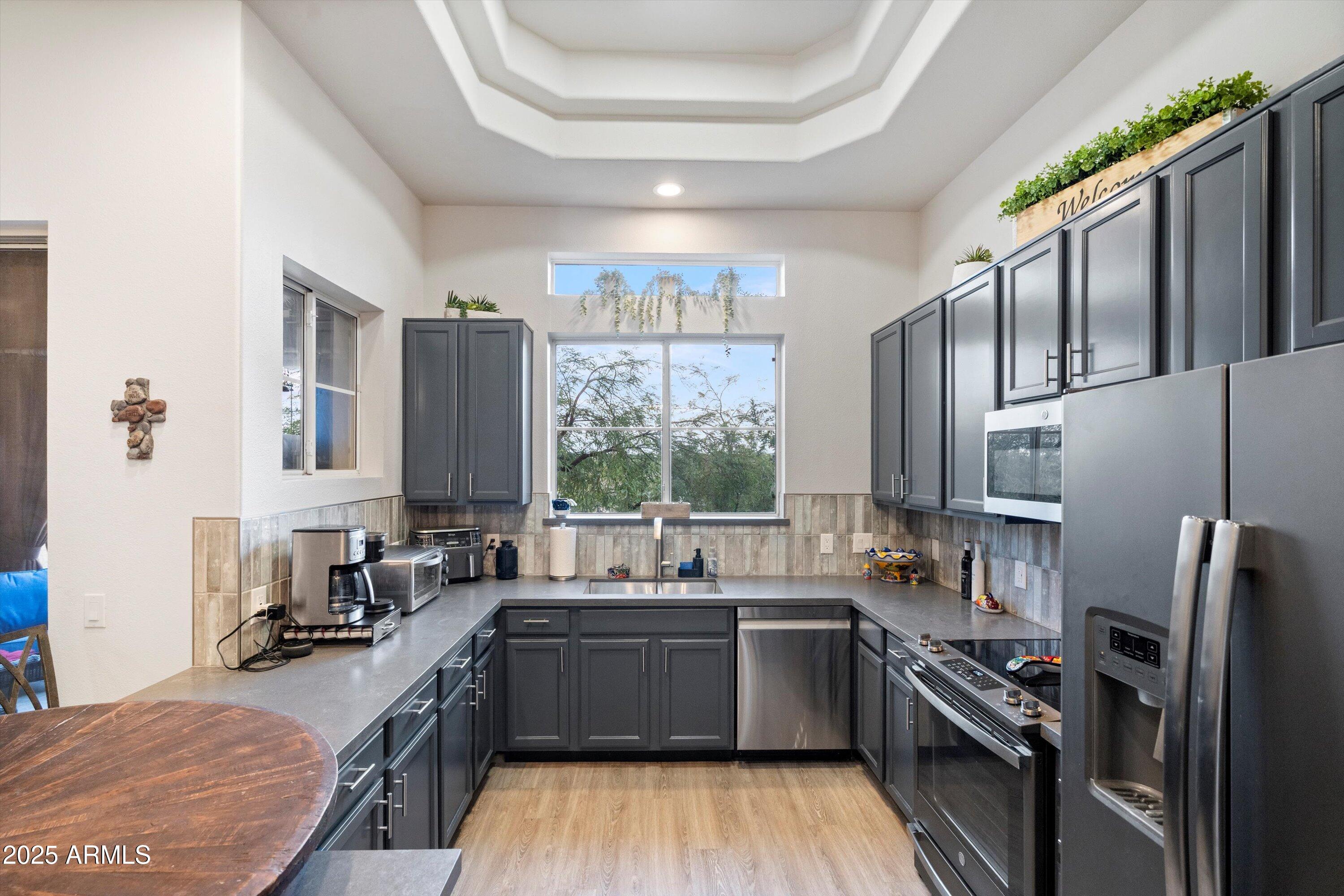 8245 East Bell Road, Unit 250 Scottsdale, AZ 85260 - Photo 20 of 48 a kitchen with a sink stove and refrigerator